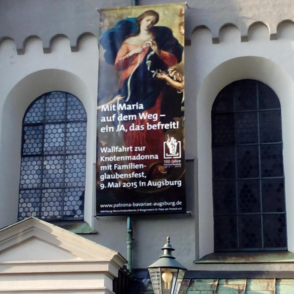 Ein großes Banner an der Außenfassade der Kirche St. Peter am Perlach kündigt den großen Wallfahrtstag an. (Foto: Bischöfliches Seelsorgeamt)
