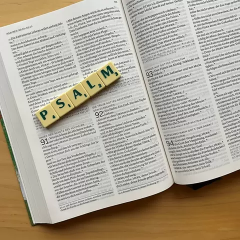 Unterhalb einer Bibel ist mit Scrabble Steinen das Wort: "Psalm" gelegt